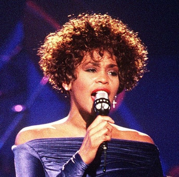 5. "I Will Always Love You" - Whitney Houston (1992): A Voice That Stopped Time (By PH2 Mark Kettenhofen, Public domain)