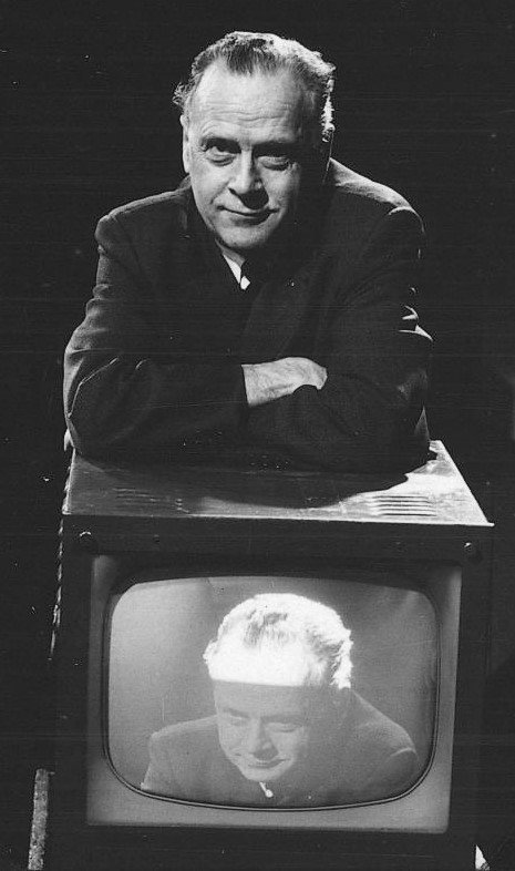 6. The Gutenberg Galaxy by Marshall McLuhan (1962) - From Vinyl to the Global Music Village (Marshall McLuhan, half-length portrait, standing, leaning on television set on which his image appears, Public domain)